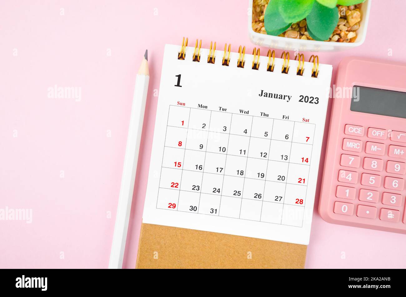 January 2023 desk calendar for 2023 year with calculator on pink color