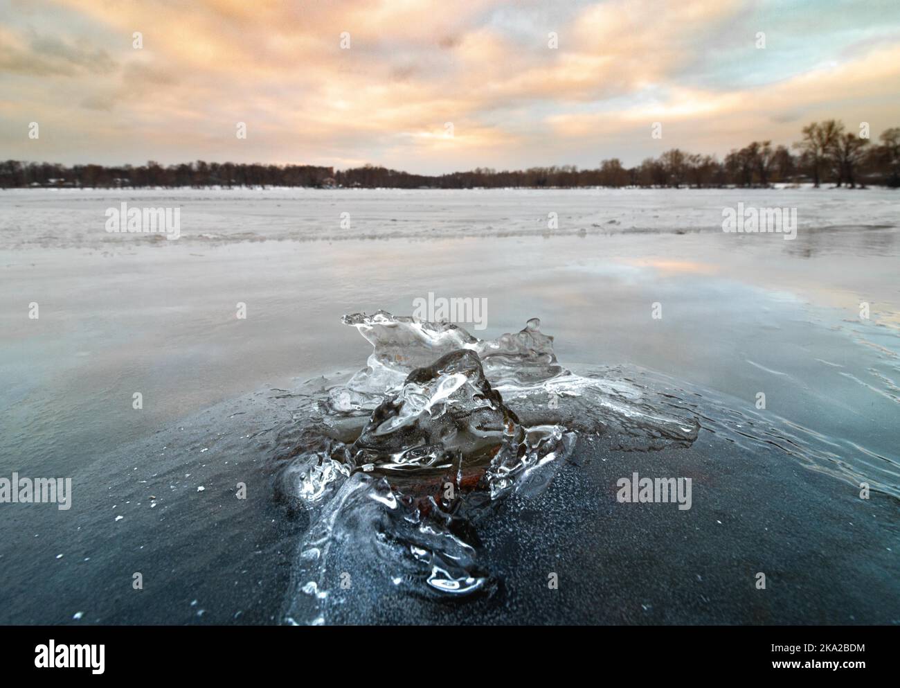 An ice composition at frozen lake Beloye in winter with a sunset background Stock Photo