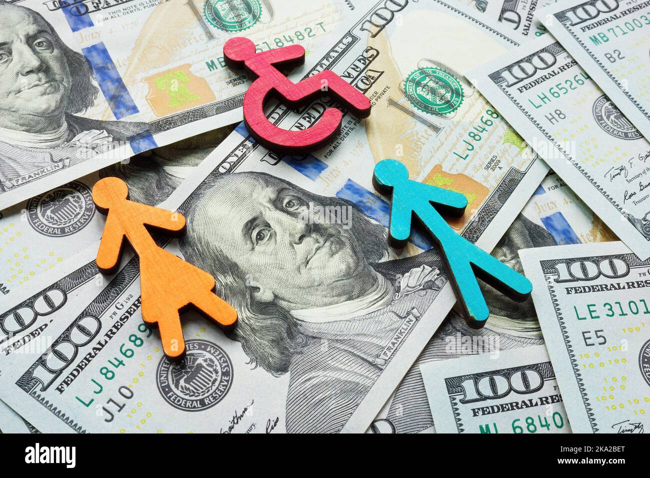 Money and figures on them as a symbol of income inequality and wage gap. Stock Photo