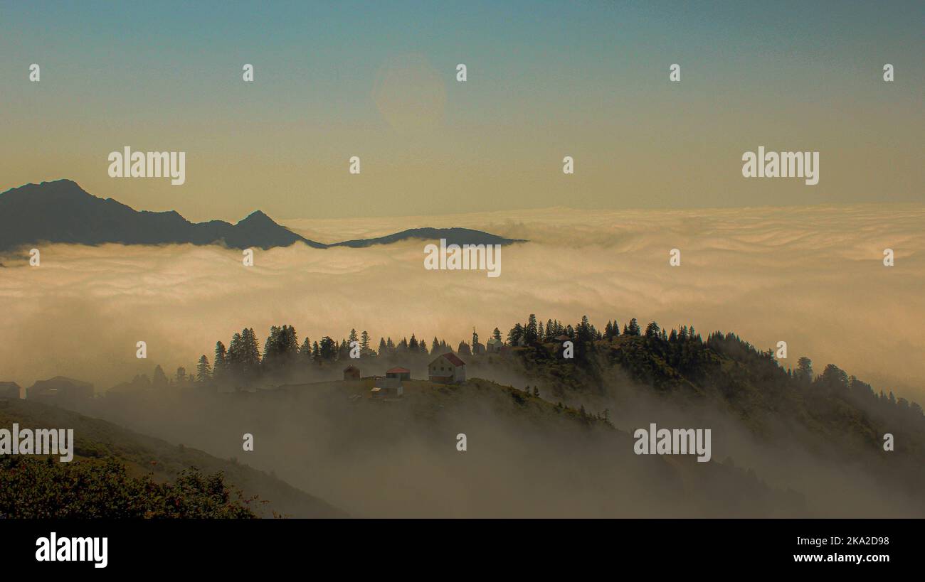An aerial view from the high mountains to the cloudy and foggy forest ...