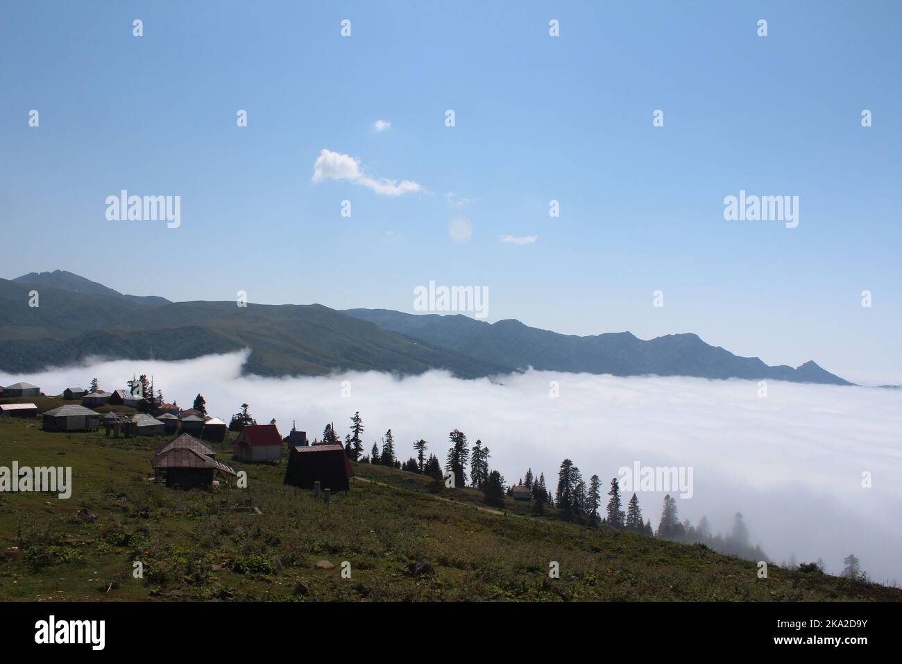 An aerial view from the high mountains to the cloudy and foggy forest ...