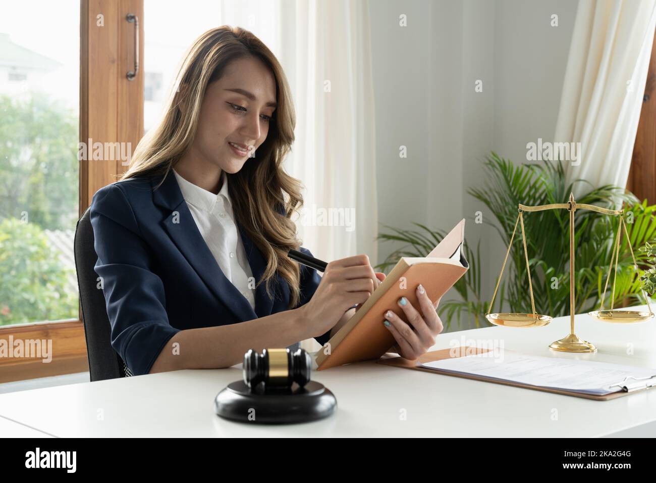 Business woman and lawyers discussing contract papers with brass scale on wooden desk in office. Law, legal services, advice, Justice and real estate Stock Photo
