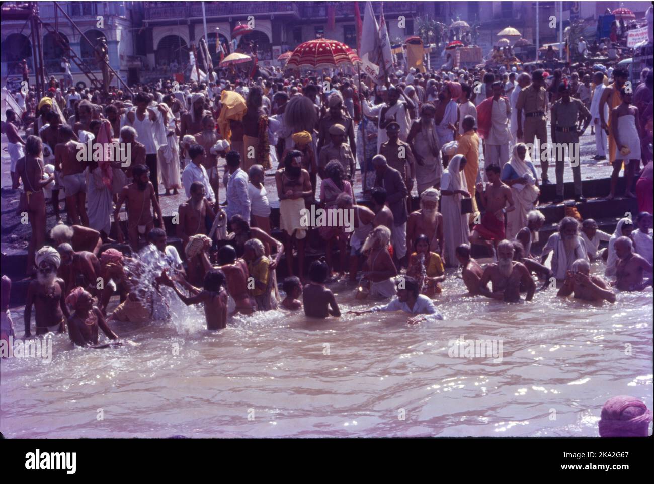 Kumbh Mela is a mass congregation of pilgrims who gather to take a bath/dip in a sacred river. The geographical location for the Kumbh Mela spans across four cities within India. Kumbha Mela is a major pilgrimage and festival in Hinduism. It is celebrated in a cycle of approximately 12 years, to celebrate every revolution Brihaspati completes, at four river-bank pilgrimage sites: Allahabad, Haridwar, Nashik, and Ujjain. Stock Photo