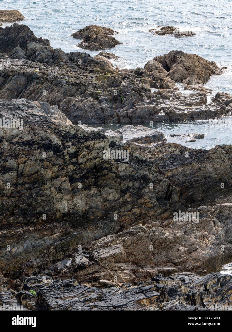 Exposed rocks on the shore. Seaside in sunny weather, rock formation ...