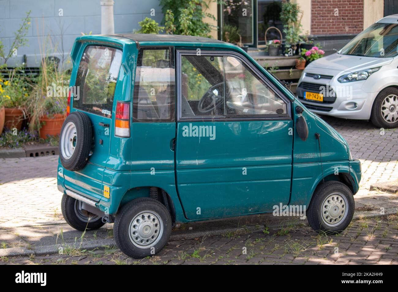 The tiny turquoise Canta LX car parked on a street, Amsterdam, Netherlands Stock Photo