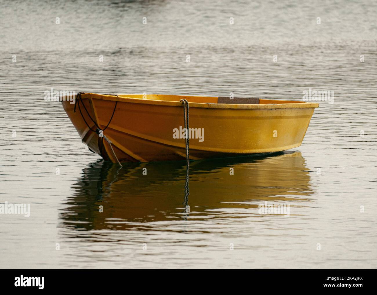 The yellow single fishing boat in the pond, close-up Stock Photo