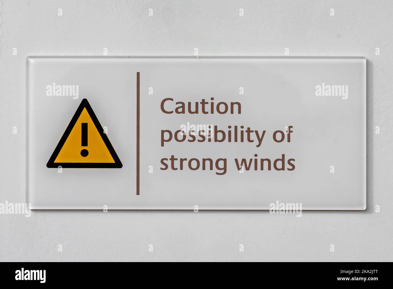 Caution possibility of strong winds warning sign with yellow