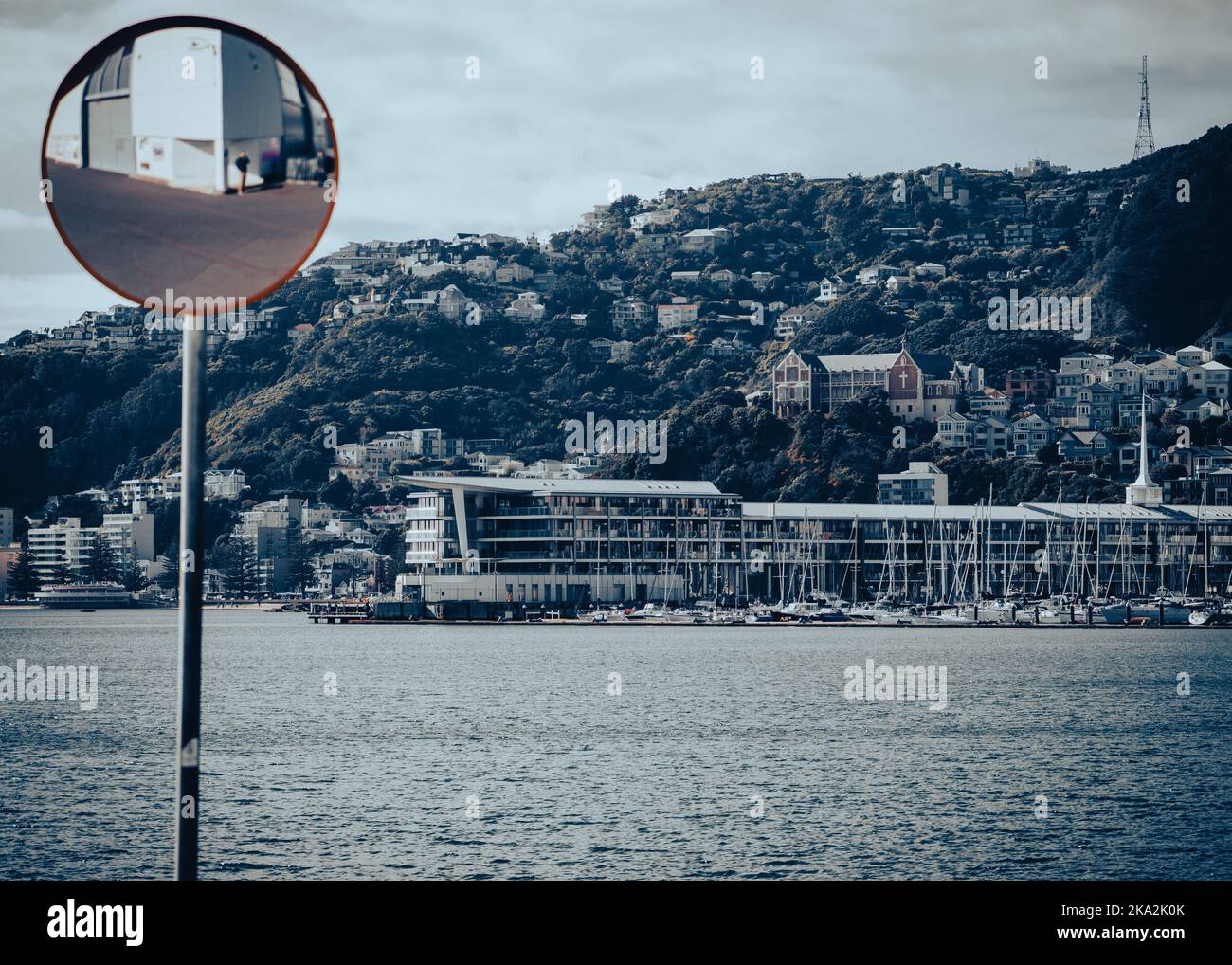 The road convex mirror with the Wellington cityscape in the background, New Zealand Stock Photo