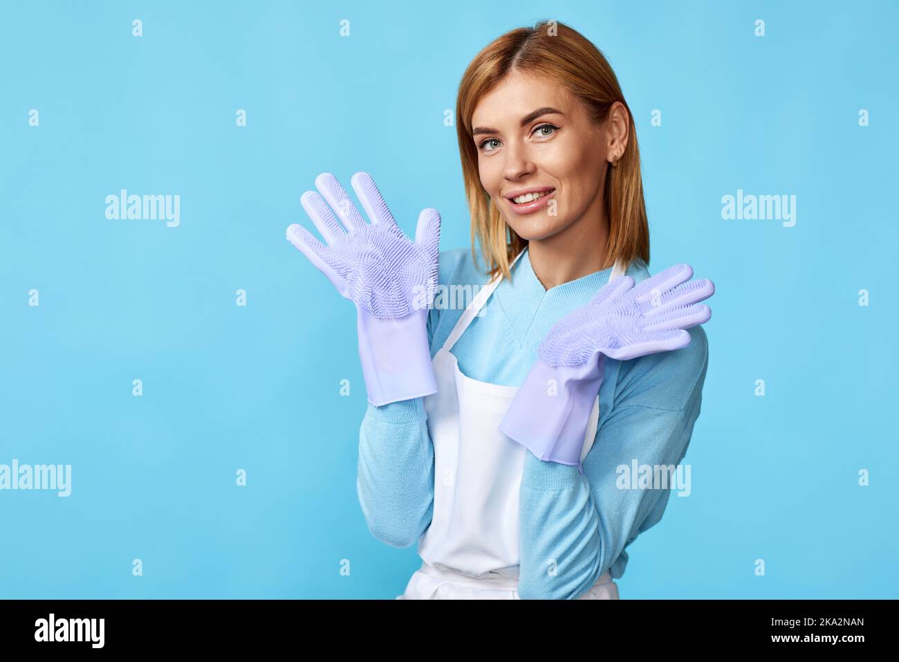 pretty woman in rubber gloves and cleaner apron Stock Photo Alamy