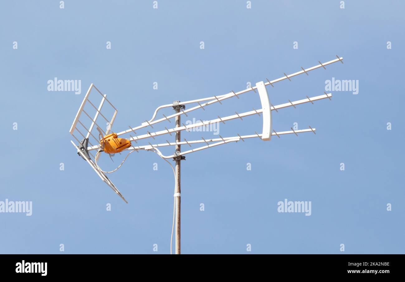 Old TV antenna on house roof with blue sky, Gran Canaria, Spain Stock Photo