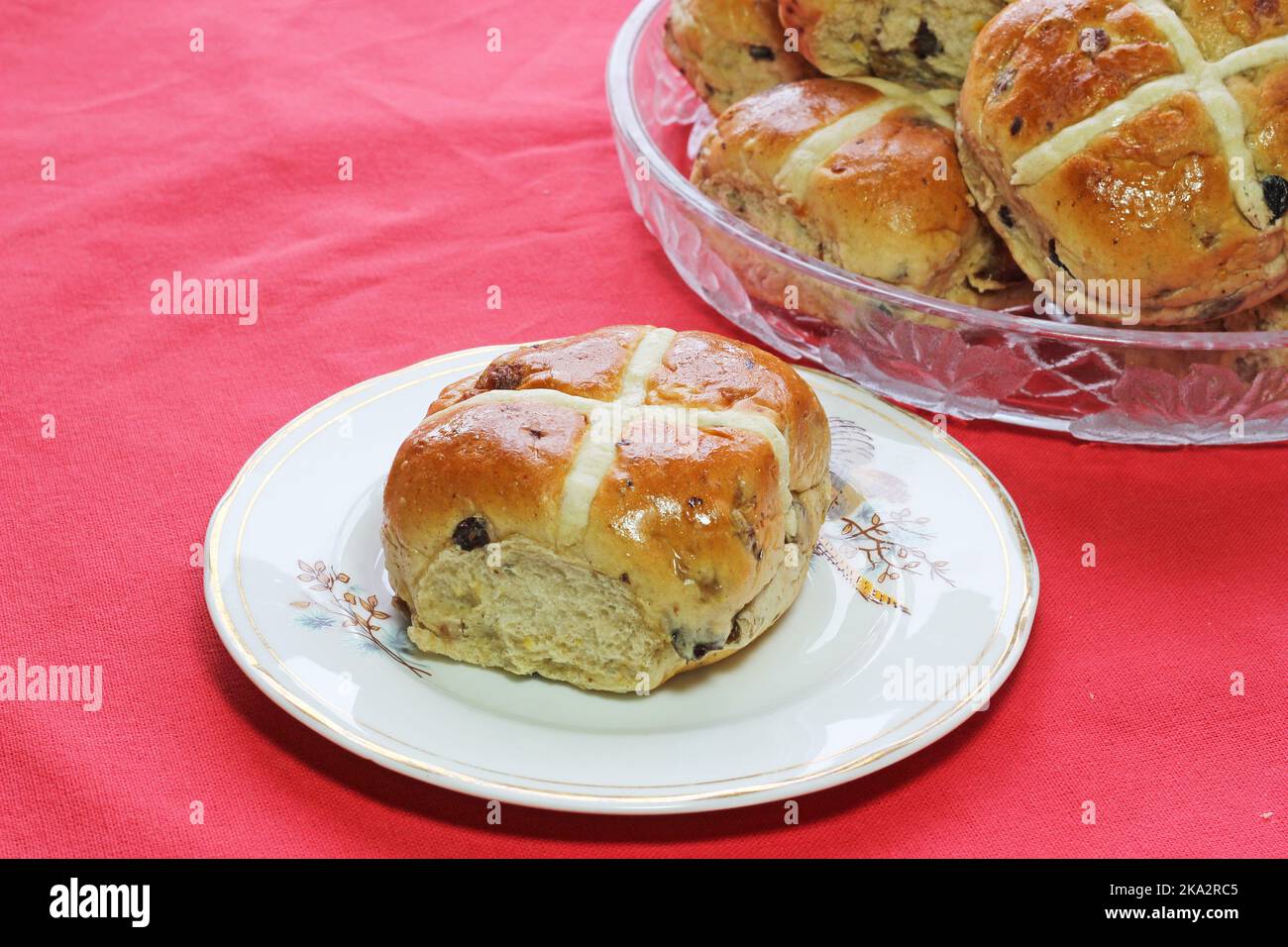 Hot cross buns on plates. Easter food celebration in United Kingdom. Stock Photo