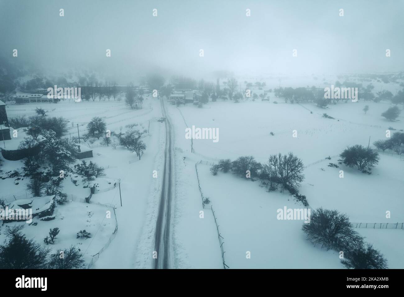 An aerial view of a snowy village in the fog Stock Photo - Alamy