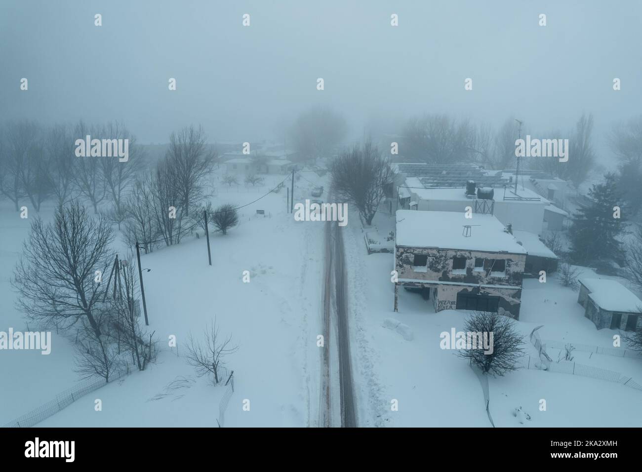 An aerial view of a snowy village in the fog Stock Photo - Alamy
