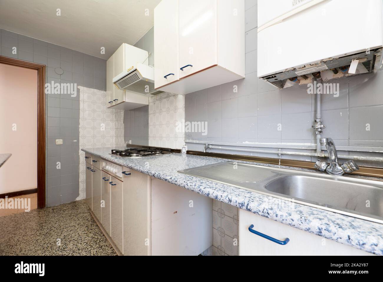 Old fashioned kitchen with blue countertops with white cabinets with ...