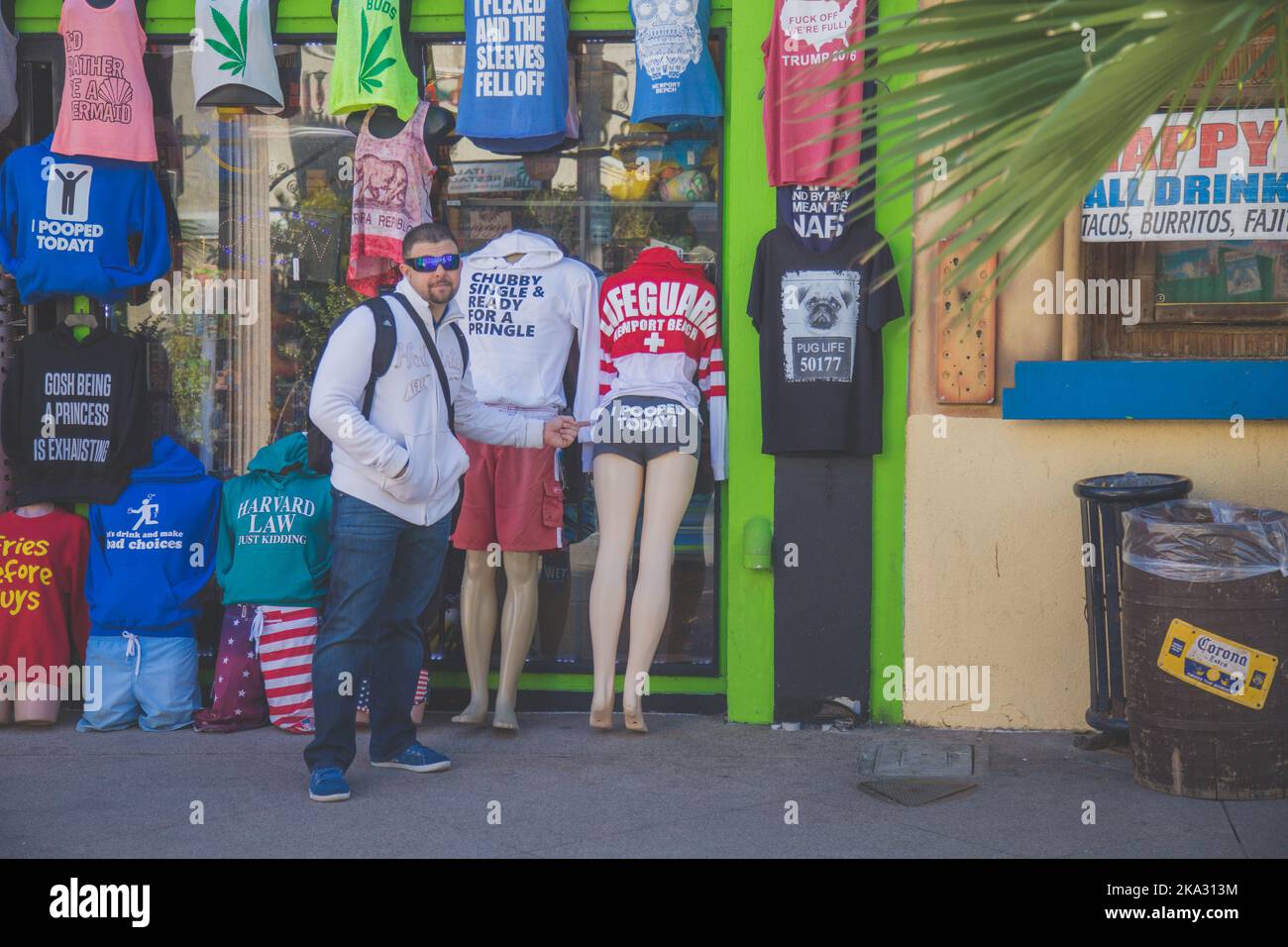 A male standing by a clothing store Stock Photo - Alamy