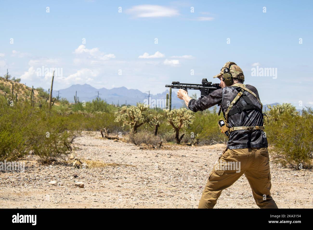 A caucasian Man shooting a AR15 Pistol using 5.56mm ammo in Arizona