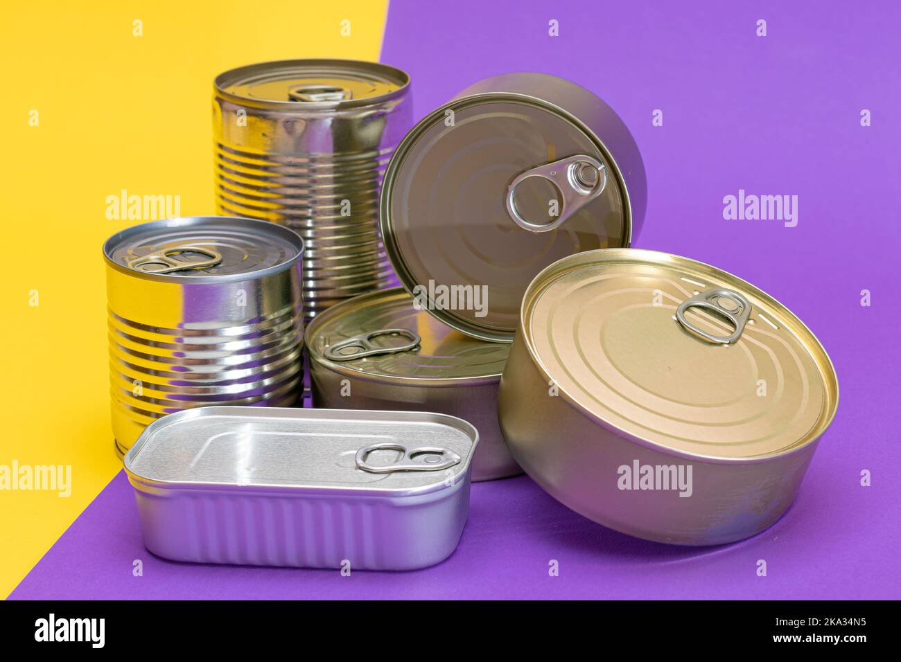 A Group of Stacked Tin Cans with Blank Edges on Split Yellow and Violet