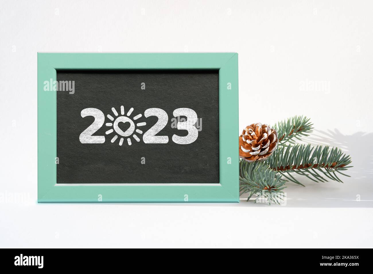 2023 caption, greeting on blackboard. Happy New Year 2023. Sun with