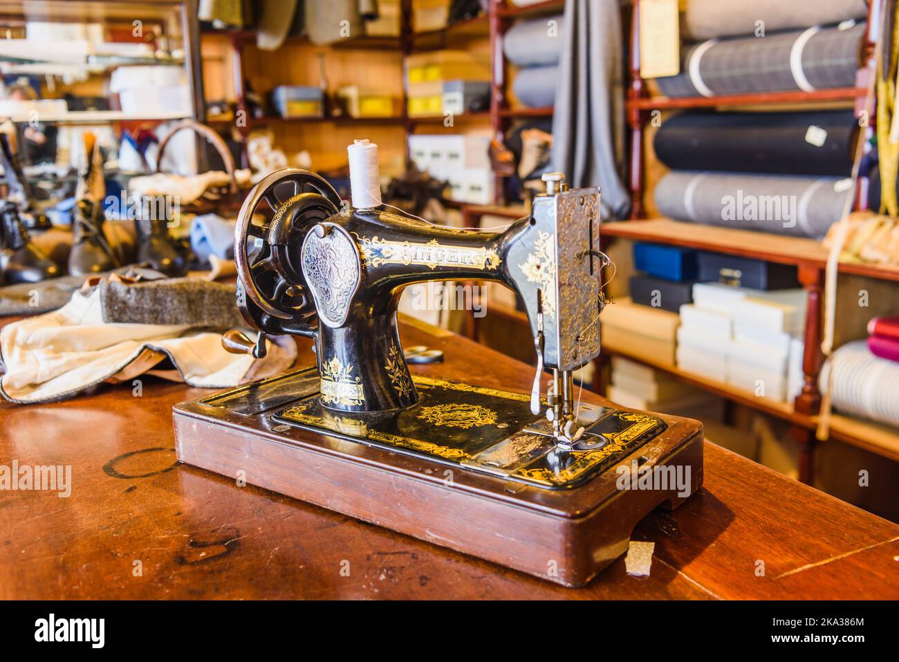 Singer sewing machine on the table inside an old fashioned tailor's