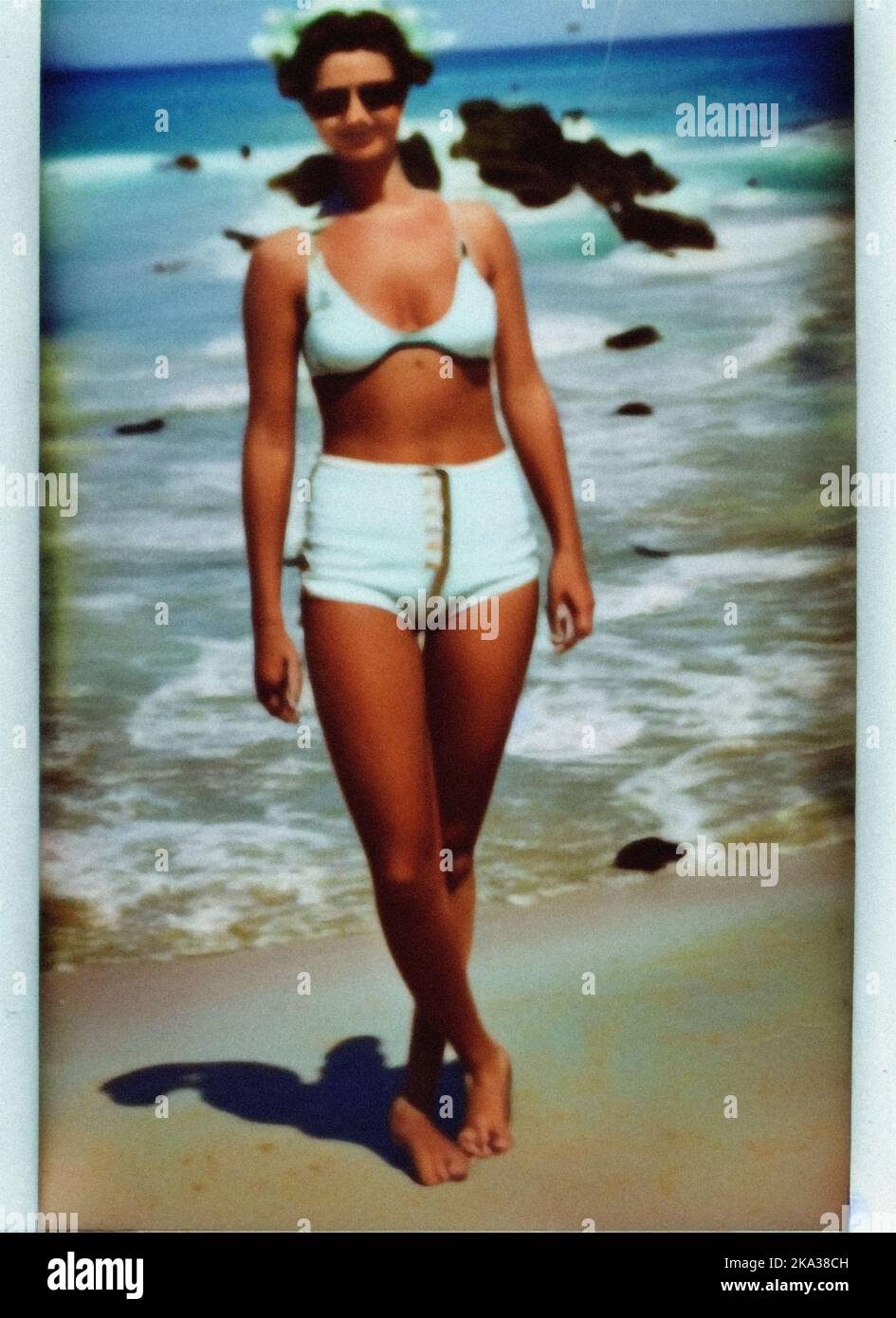 A young woman in a swimsuit on the beach, vintage retro photo Stock Photo