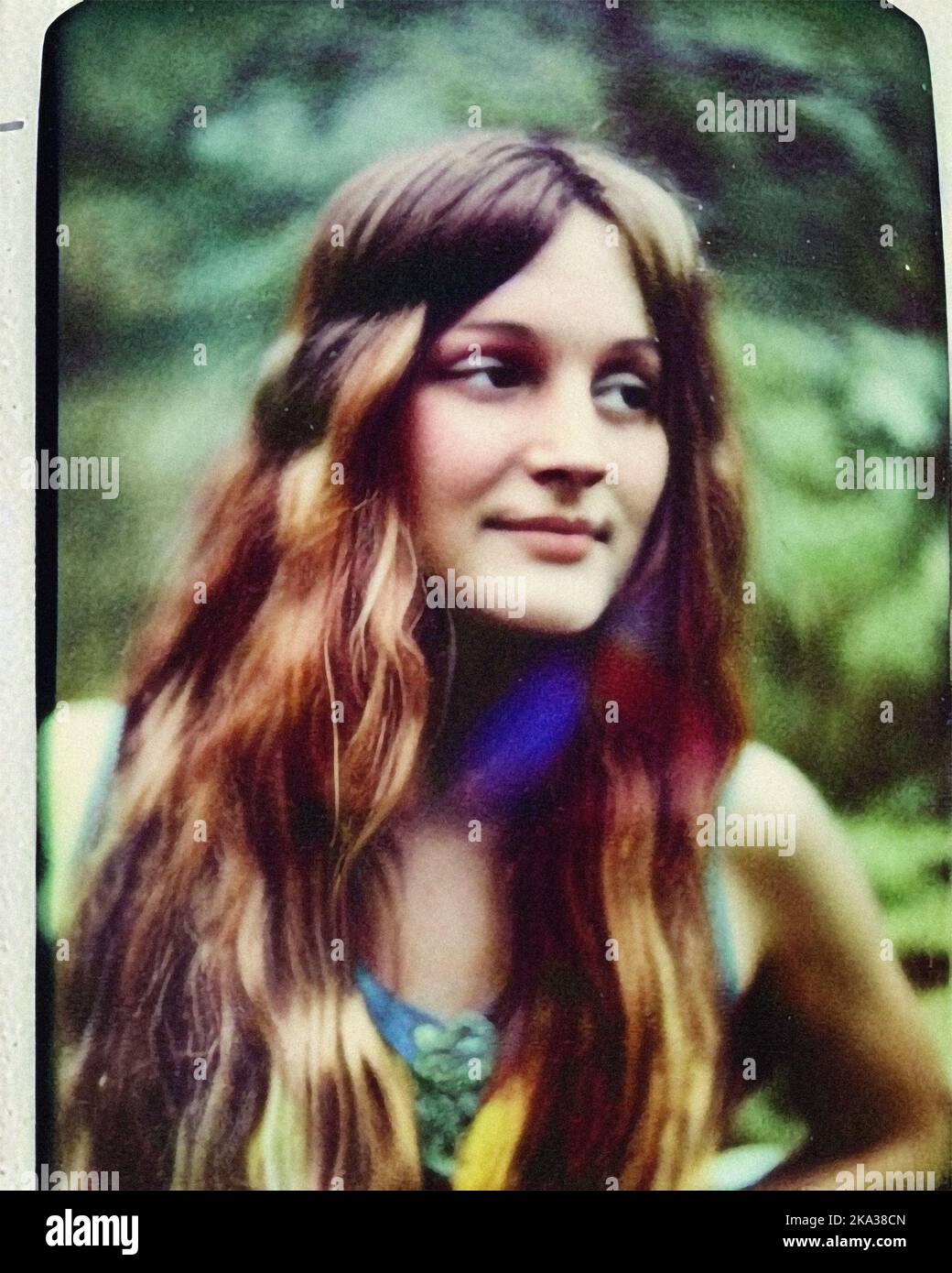 A young hippie woman in the forest, vintage retro Polaroid Stock Photo