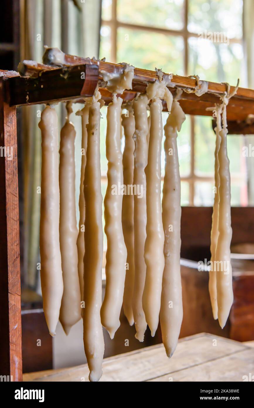Handmade candles drying on a rack inside a house Stock Photo Alamy
