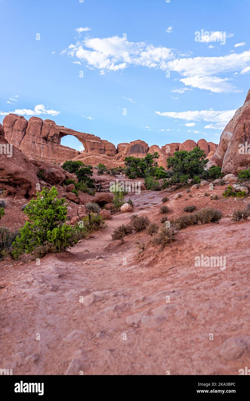 Arches National Park with Skyline Arch in background canyon vertical view on trail hike in Utah and nobody in evening dusk twilight Stock Photo