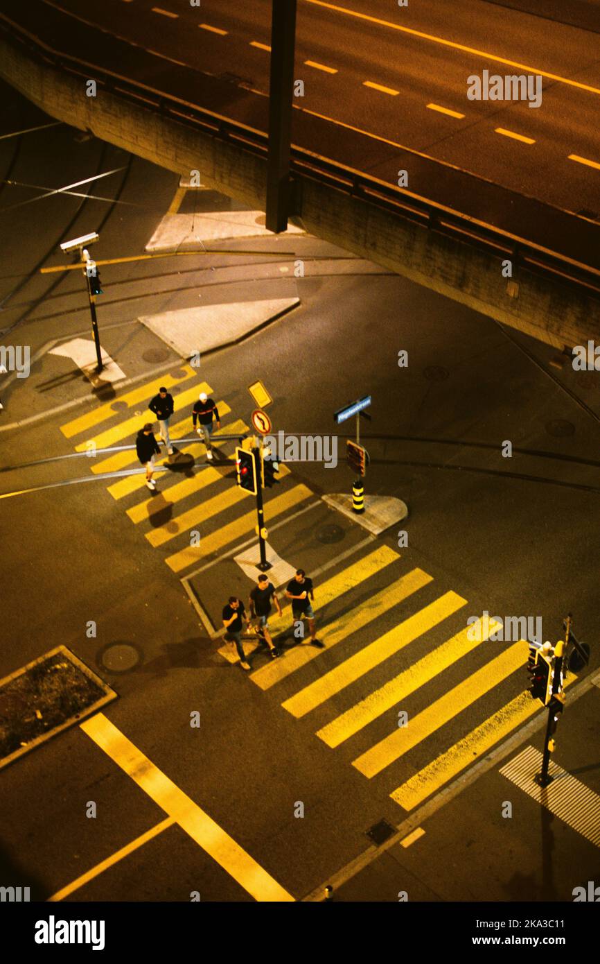 An areal view of people crossing the street at night Stock Photo