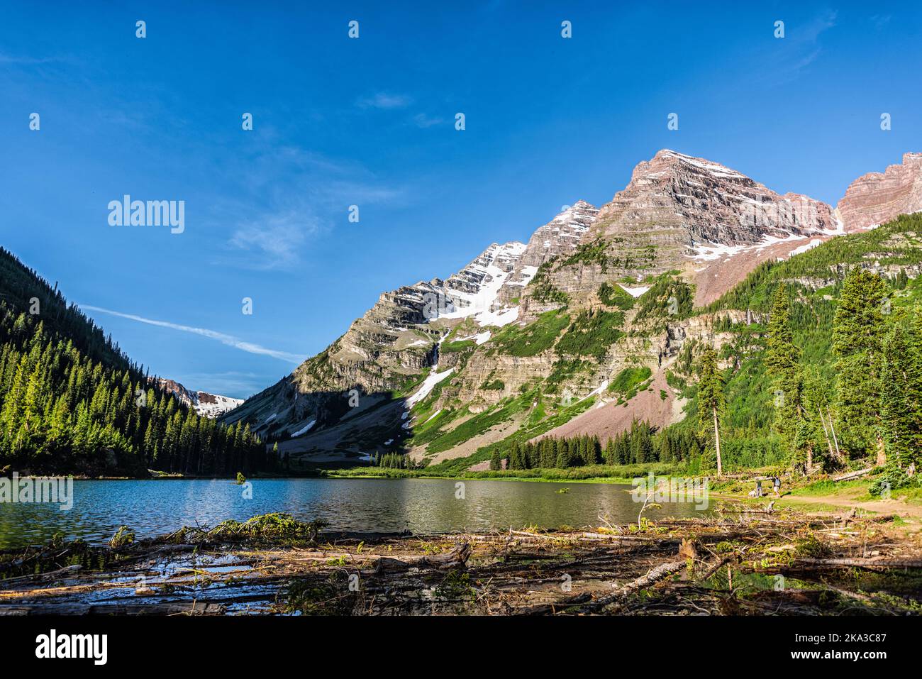 Aspen, Colorado Maroon Bells area with Crater lake water and rocky mountain peak in summer on trail wide angle view with avalanche debris logs Stock Photo