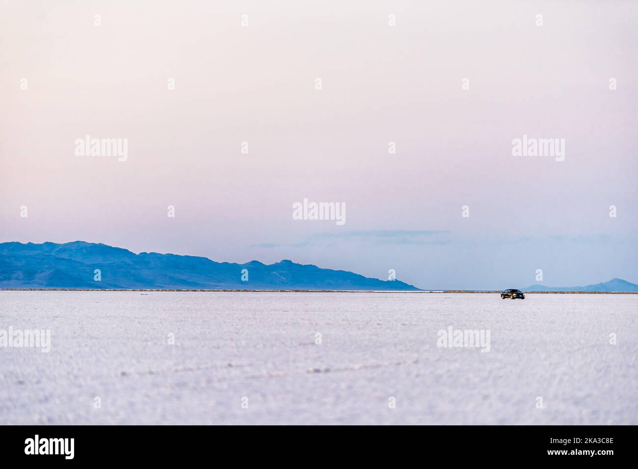 West Wendover, USA car driving on white Bonneville Salt Flats near Salt