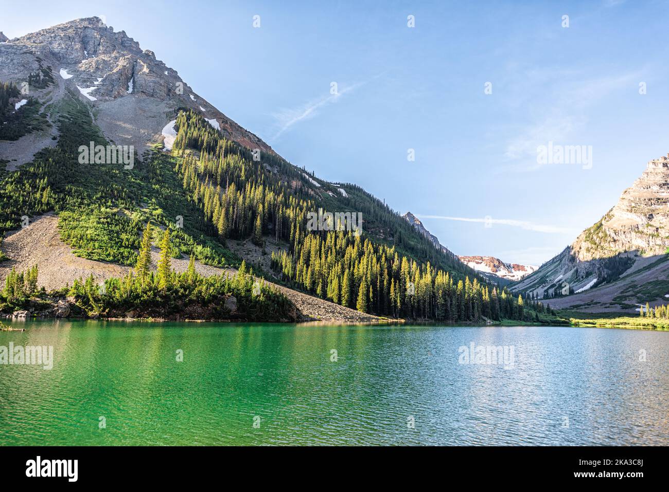 Creater Lake in Colorado Maroon Bells area with rocky mountain snow peak view in summer with nobody and reflection in beautiful green water Stock Photo