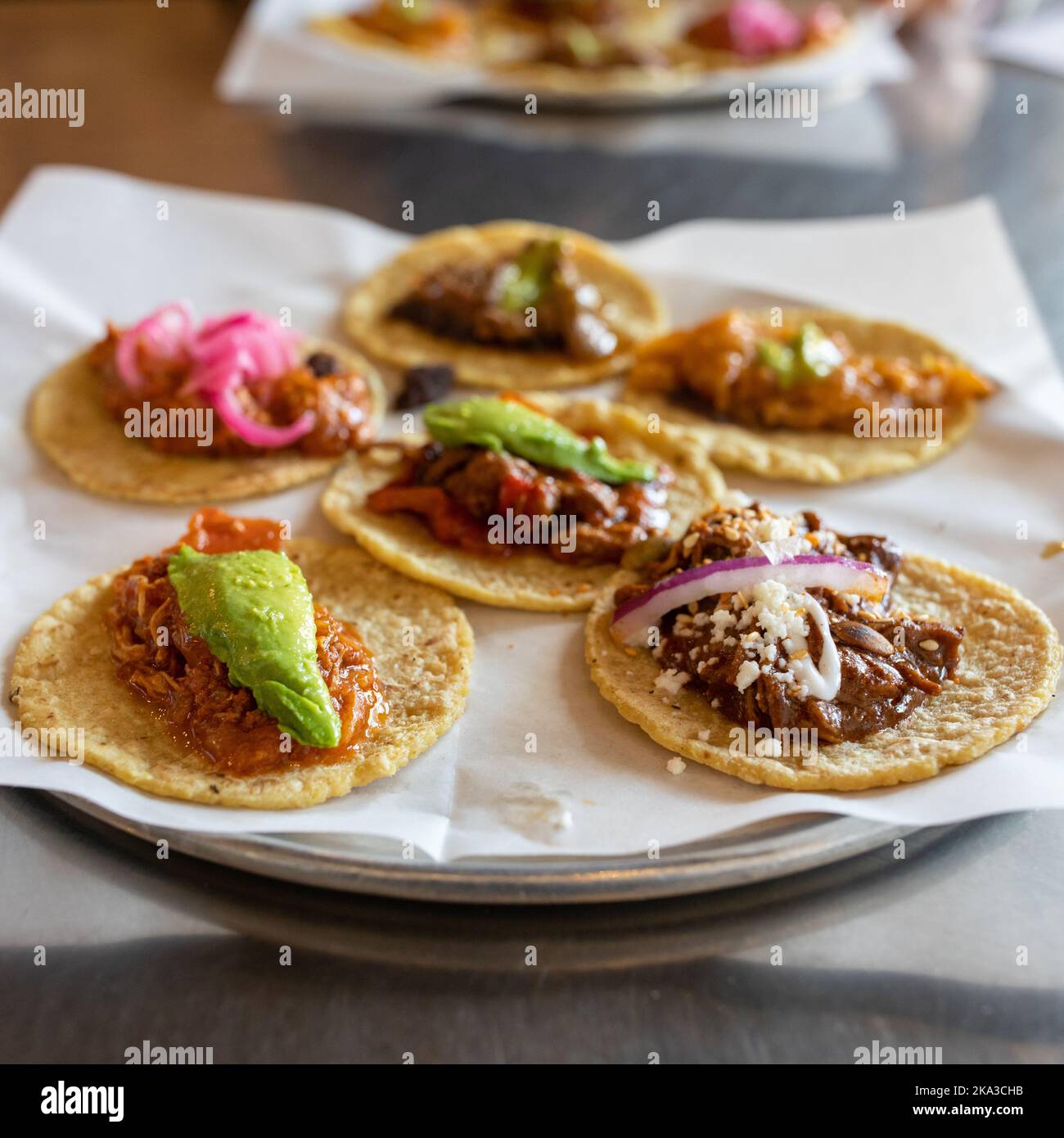 An assortment of soft shell tacos with beef, chicken, and pork