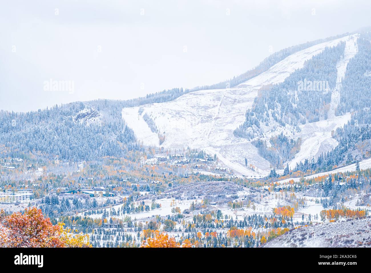 Aspen, Colorado town houses in rocky mountains roaring fork valley from high angle view during autumn season changing into snowy winter with yellow fo Stock Photo