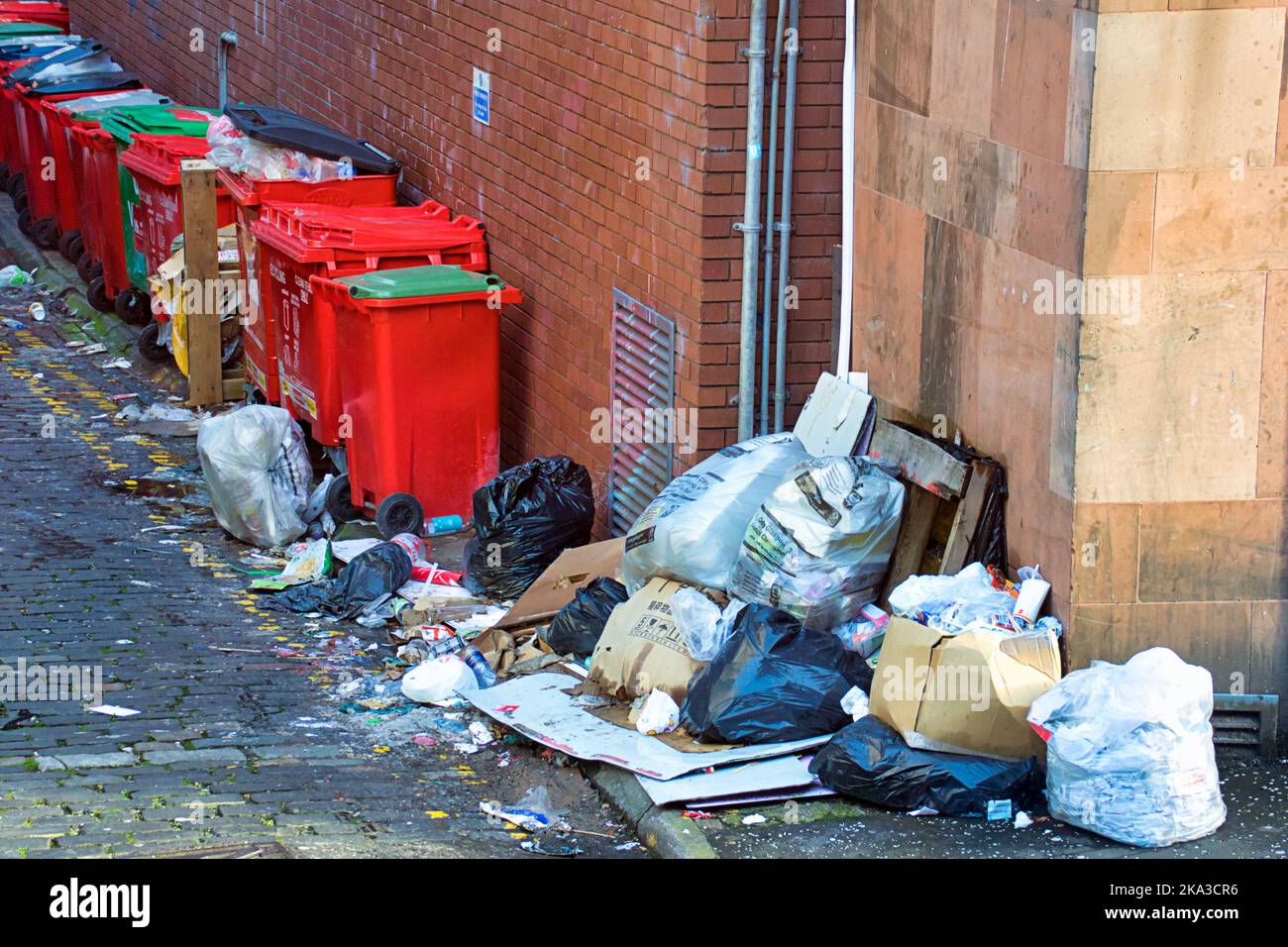 overflowing rubbish bins alley on hope street Glasgow, Scotland, UK