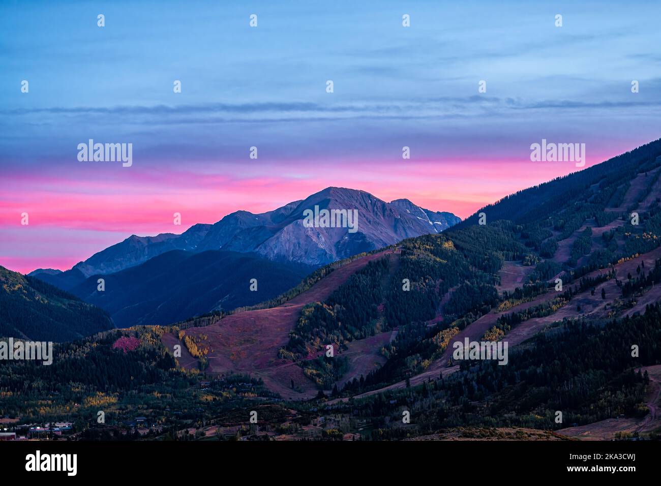 Pink purple sunset in Aspen, Colorado with Rocky mountains of Buttermilk ski slope mountain in