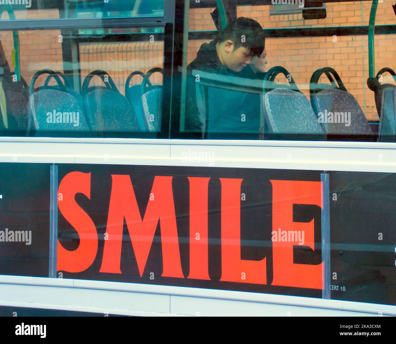 Smile advert on bus with passenger Stock Photo