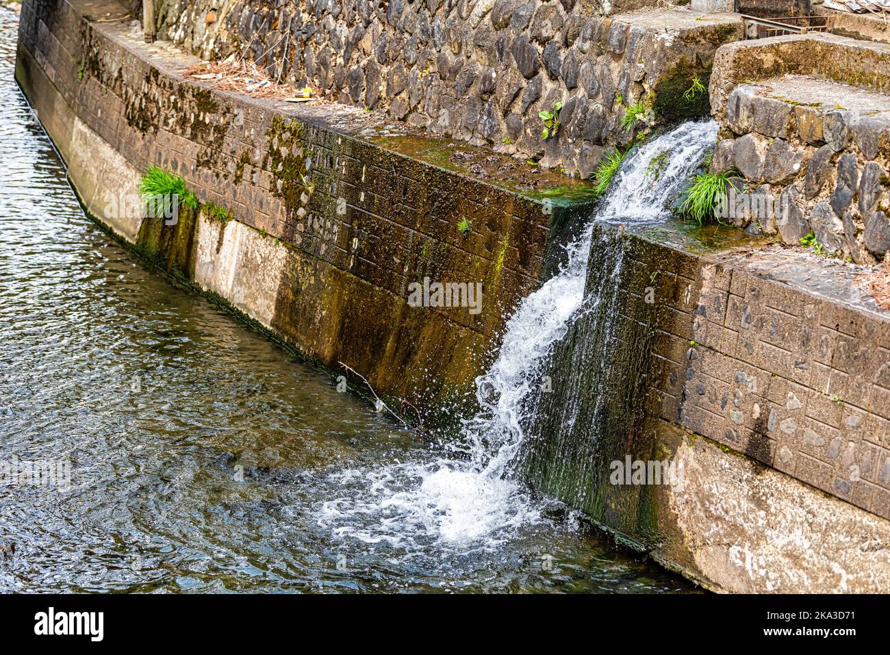 Takayama, Japan with small waterfall at Enako river in Takayama, Gifu prefecture of Japan with water in early spring by traditional village canal Stock Photo