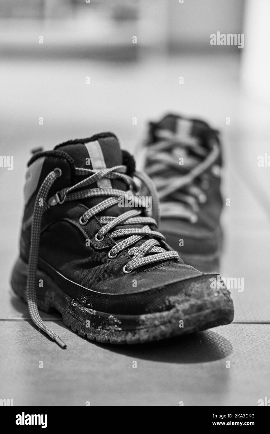 A grayscale vertical shot of a dirty hiking boot Stock Photo Alamy