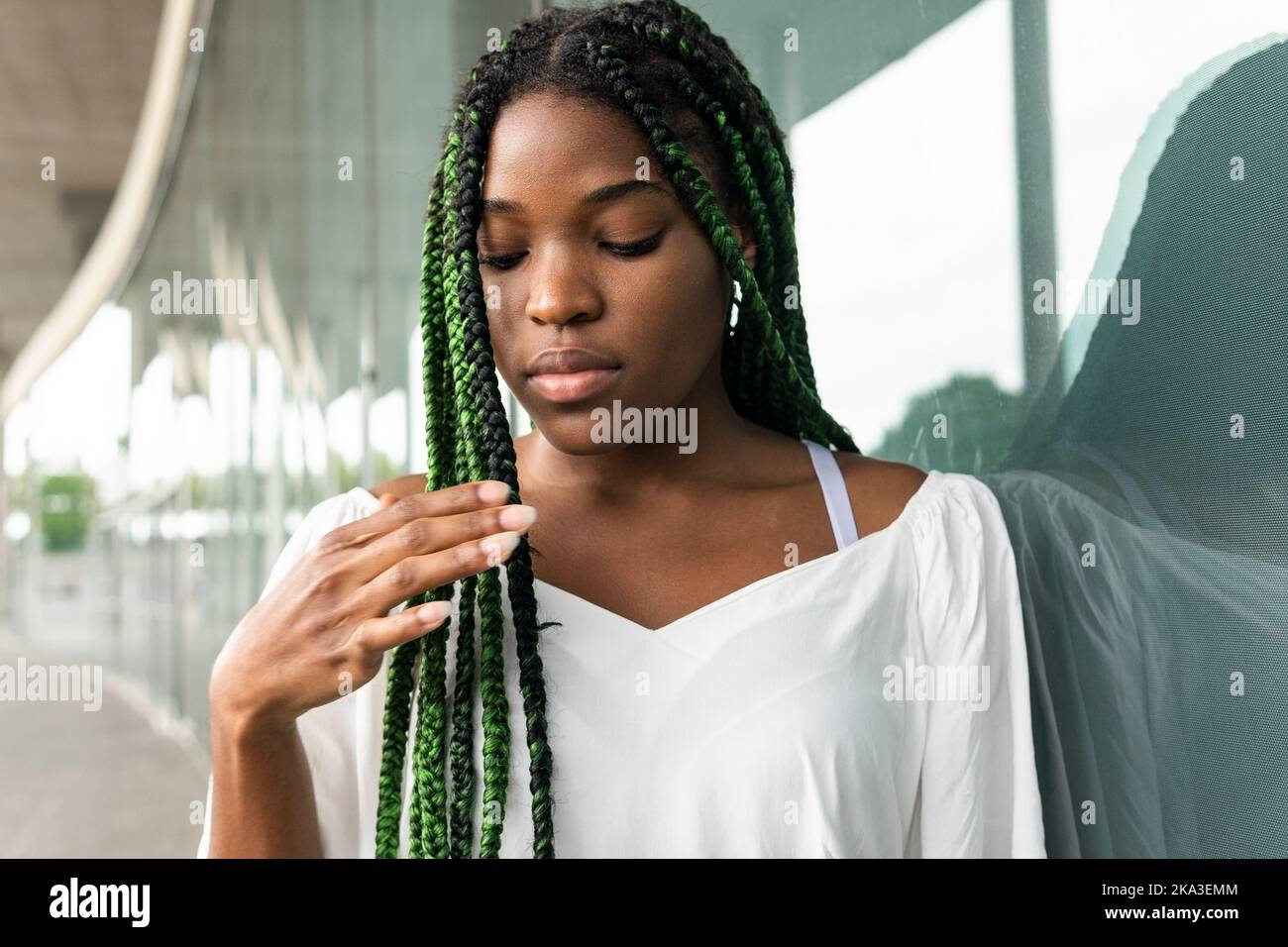 Cool young African American woman with long afro braids standing at ...