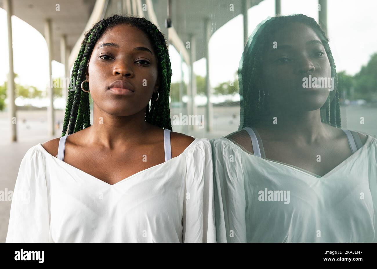  Cool young African American woman with long afro braids standing at ...