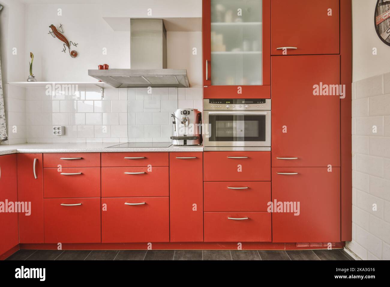 Corner cupboards and table with chairs located in red kitchen of
