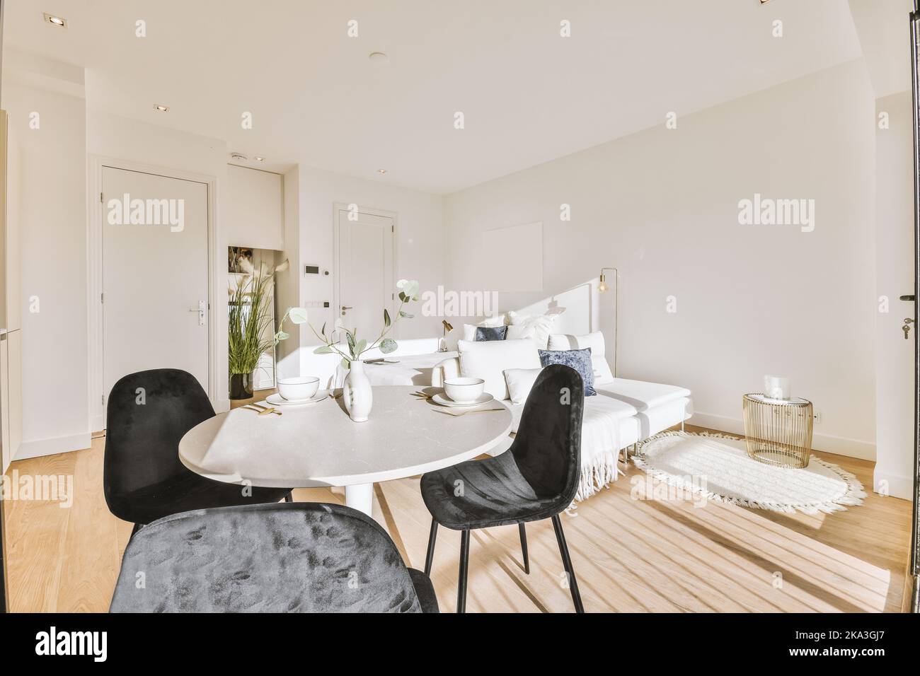 White sofa located near dining table in open plan living room in modern