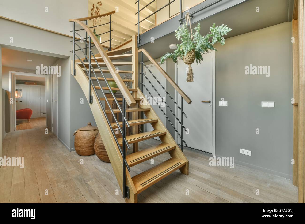 Wooden staircase in corridor of modern house with parquet floor in ...