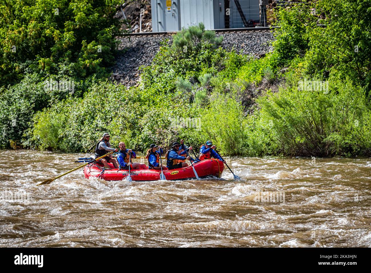 Glenwood Springs, USA - June 29, 2019: Group of candid people on boat in Colorado's Roaring Fork River white water rafting in summer season Stock Photo