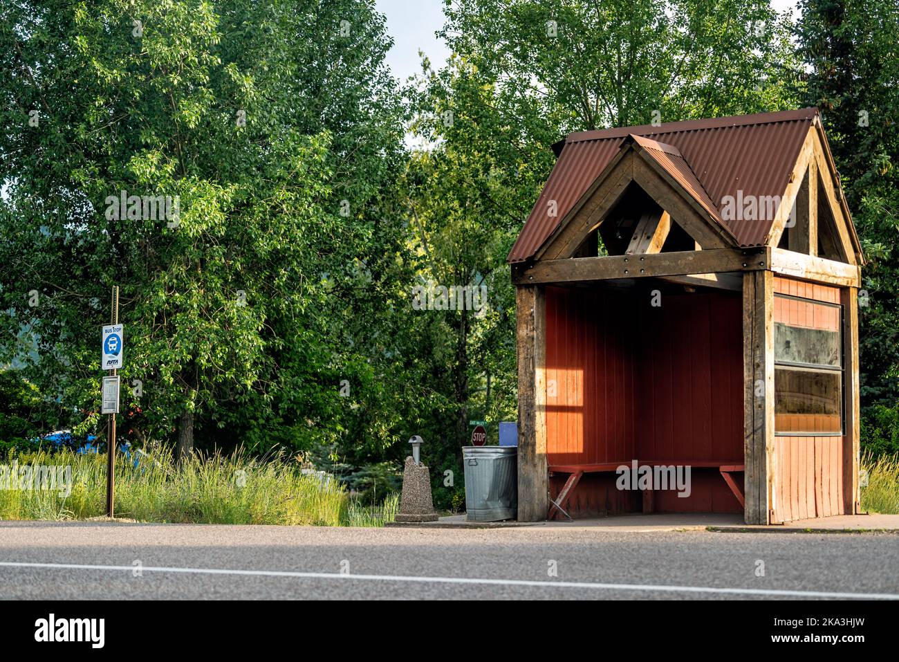 Carbondale, USA - July 1, 2019: Road street near Aspen, Colorado town with shuttle RFTA public transportation bus stop sign and nobody at shelter buil Stock Photo