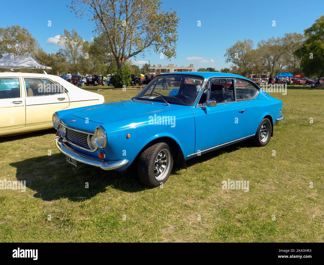 Old blue Fiat 1600 coupe hatchback two door 1970 in the countryside. Sunny day. Nature, grass, trees. Classic car show. Stock Photo