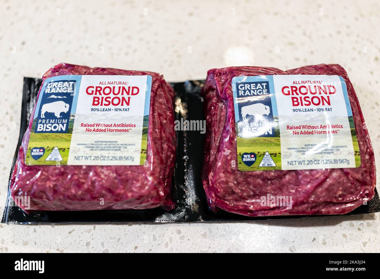 Naples, USA - April 29, 2022: Macro closeup of two plastic wrap red raw uncooked ground bison meat from Great Range brand company grass-fed raised wit Stock Photo