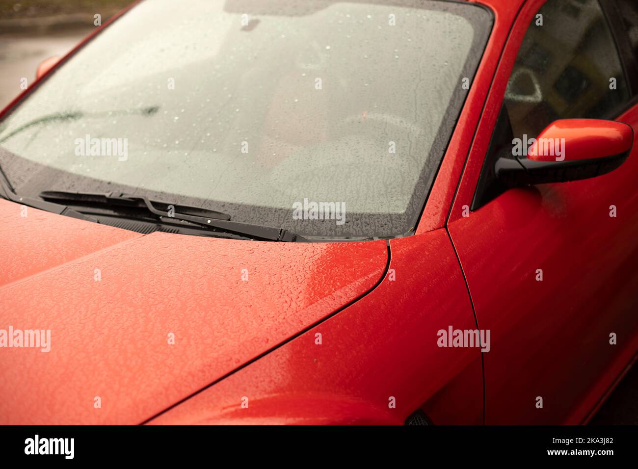 Red car. Wet car in parking lot. Windshield of transport Stock Photo Alamy
