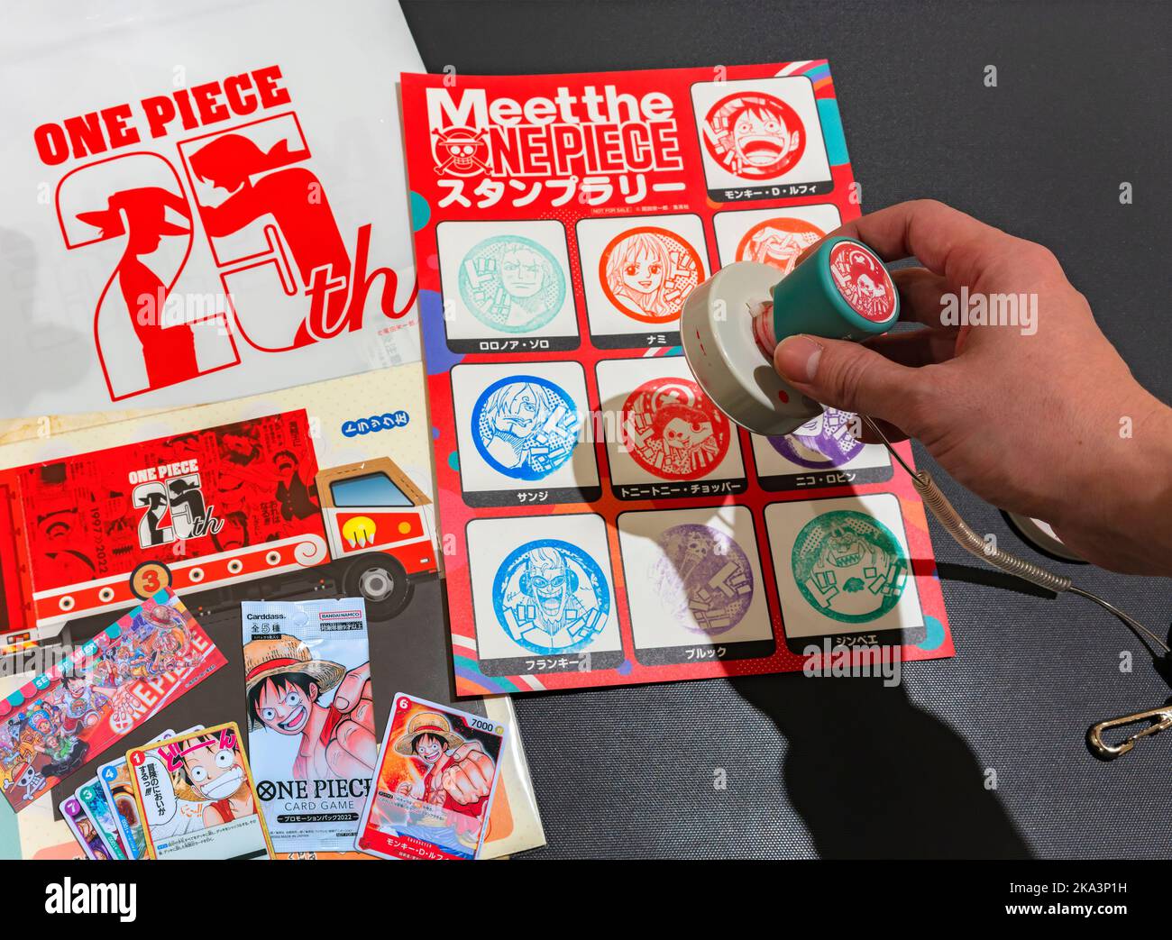 saitama, kawaguchi - sep 29 2022: Hand holding a rubber stamp depicting a character of the japanese manga and anime series One Piece to celebrate its Stock Photo