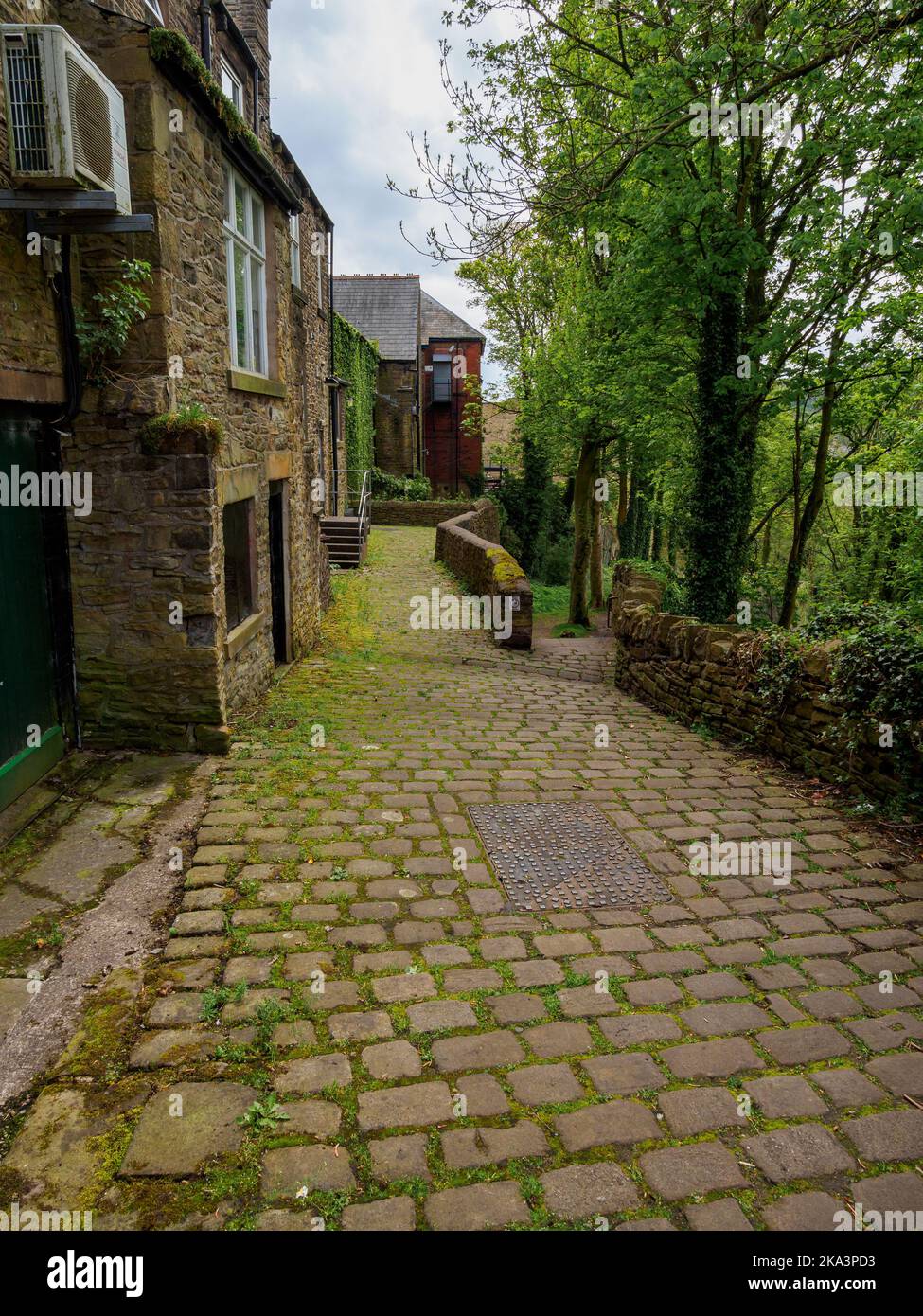 old cobbled lane behind stone built property New Mills village